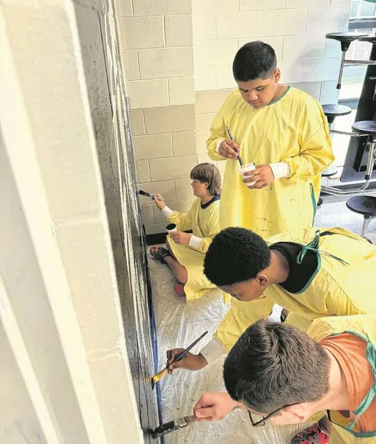 Roseboro-Salemburg Middle students Waylon Sealy, Kaiden Logan, Jayden Caceres, and Grayson Pope assist in painting the mural.