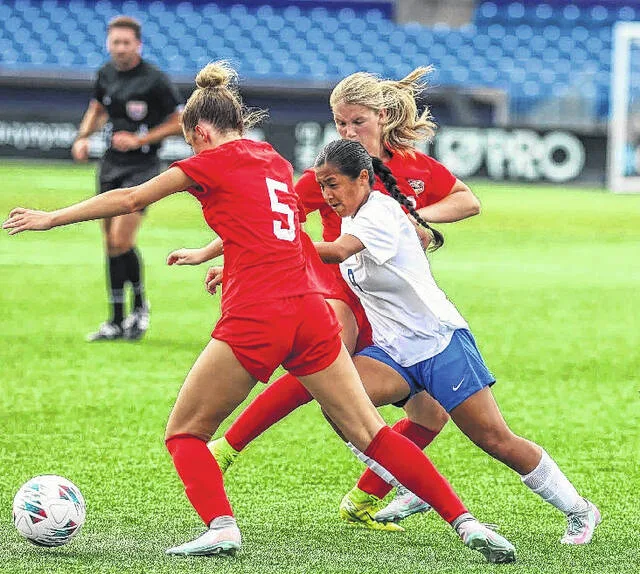 Denisse Jorge-Garcia fights off two West All-Star defenders as they close in to remove possession of the ball from her during the East-West All[-Star game earlier this week.
                                 Courtesy Photo | North Carolina Coaches Association