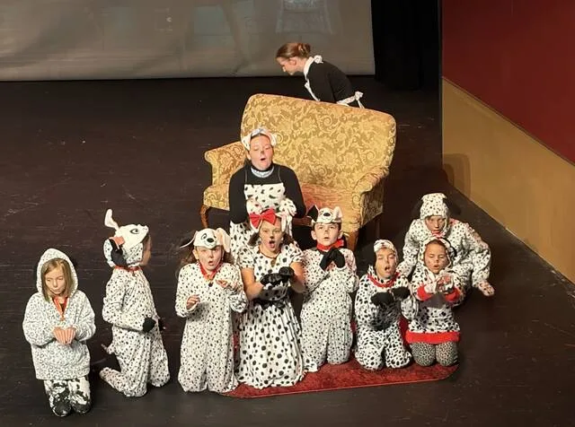 Rebecca Sampson, portraying the nanny, is pictured with the Dalmatians, front row: Kaydee McLamb, Charlotte Rouse, Vivian Someliana-Lauer, Ryanne Squibb, Mateo Vasquez, Allison Bass, and Kaileigh Seals. Back row: Ella Grace Black and Zach Johnson
                                 Courtesy photo | Linda Jewell Carr
