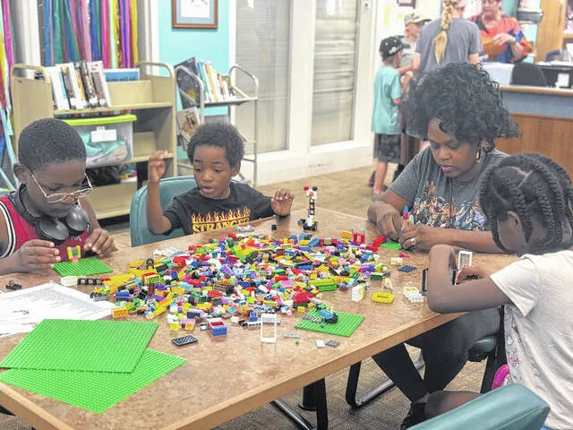 Ezra, Benjamin, Sidra, and Rachel build Legos together as a family during this weeks Lego Lab held at the J.C. Holliday Library in Clinton.
                                 Dylan Atwood | Sampson Independent