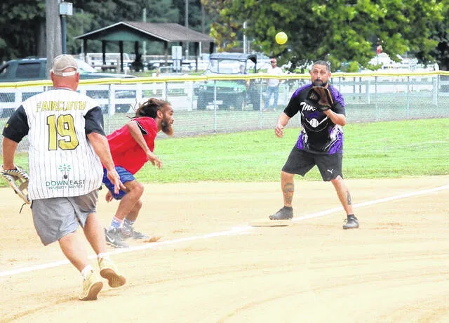 Thrown Togethers Kevin Faircloth and Josh Smith (on base) trap NGNLs Woo Lamb in a jam situation, as both defenders could make the tag. NGNL defeated Thrown Together in their playoff match 20-9 Monday evening.
Trevon McGlone | Sampson Independent
