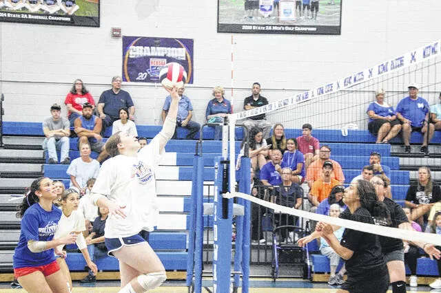 Midway High School junior Katlyn Vann makes an offensive play on the court against the Midway Alumni team in the All-American Alumni Game held Tuesday night. The varsity and junior varsity players teamed up to defeat the alumni 25-18. The game also served as an opportunity for donations to Midways Backpack Program, where nonperishable items were donated by members of the community.
                                 Trevon McGlone | Sampson Independent