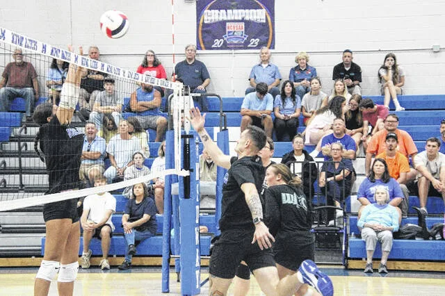 Lady Raider freshman Jamison Shelton rises to the net for a block attempt on Midways new volleyball coach Paul Hairfield.
                                 Trevon McGlone | Sampson Independent