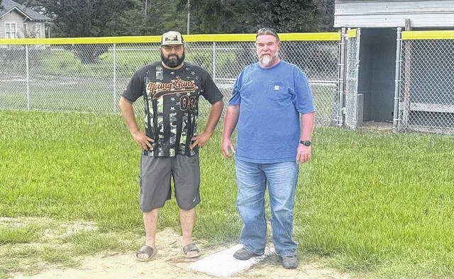 Garland Volunteer Softball League Committee members Michael Spell and Todd Marshall stand on first base of one of the Garland ball fields. The two men help run the local league in town, revived in 2016 after a hiatus period where the league had stopped play. Today, the organization continues to offer local kids and adults the opportunity to play the game of softball, just as Spell and Marshall had done as kids. The adult league resumes play on Monday, Aug. 31
Trevon McGlone | Sampson Independent