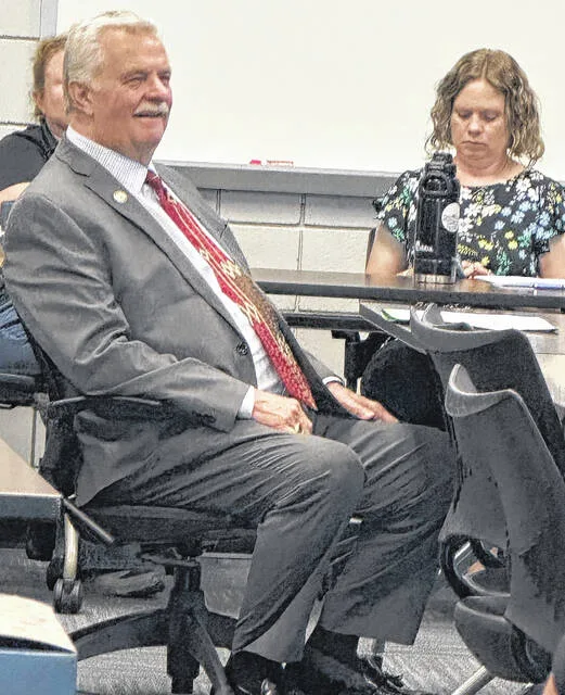 Chris Fann cracks a smile as he watches a slide regarding his service to the SCC board that spans over four decades.