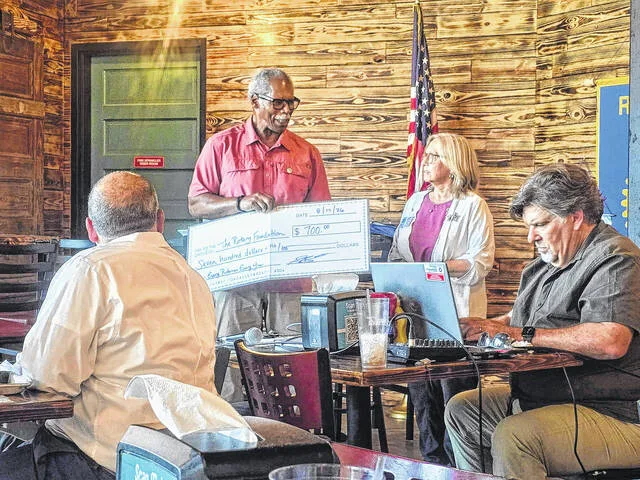 Shawn Braswell, District Governor of Rotarys District 7730, which encompasses Sampson, speaks with members of the noon-day Clinton-Sampson Rotary, about growing membership in the long-time civic organization and spreading Rotarys message of humanitarian service and advancement of peace around the world. After her discussion, Clinton-Sampson Rotary President Dr. Ted Thomas presented Braswell a check for $700 to the Every Rotarian, Every Year campaign, money that is split between District Designated Funds, which comes back to clubs through grants, and the World Fund, which support Rotarys international initiatives.