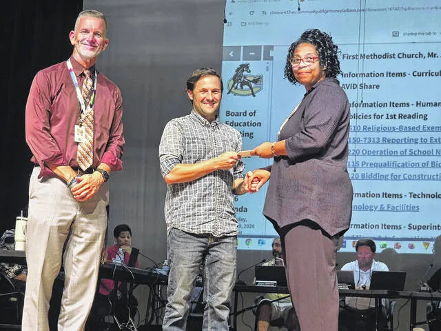 Superintendent Dr. Wesley Johnson and Human Capital Sheila Peterson received the gift cards from First Methodist Associate Pastor Joel Wise to buy needed food and supplies from both Walmart and Food Lion.