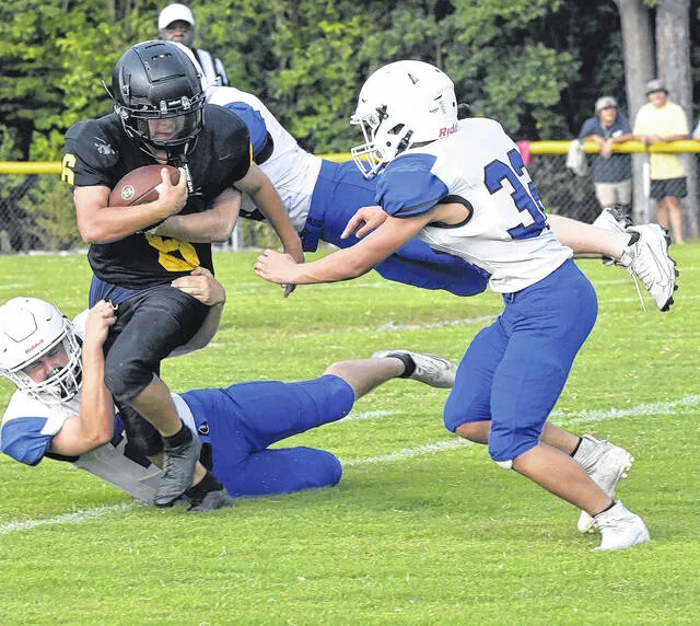 A gang of Raiders surround Hobbton tailback Julius Pope-Flores on one his carries.
                                 David Johnson | Sampson Independent