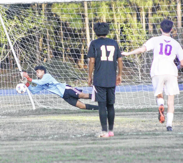 Leopard goalkeeper Gerson Navas makes a dive save to his right to deny Rosewood of a goal.
                                 Courtesy Photos | Merari Acosta