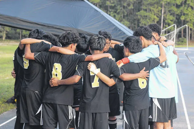 The Lakewood Leopards at halftime huddle up to discuss what they can do to get back in the game. They were down 2-0, but managed to storm back in the second half to win 3-2 against Rosewood High School on Monday evening at home.
                                 Trevon McGlone | Sampson Independent