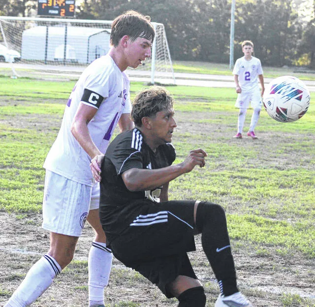 Lakewoods Brandon Martinez fights off the pressure of a Rosewood defender as he balances the ball.
                                 Trevon McGlone | Sampson Independent