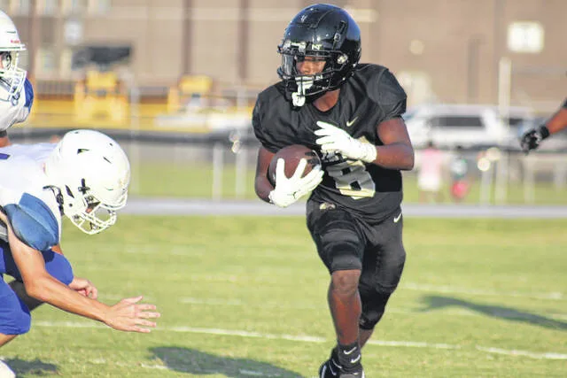 Clinton Dark Horse sophomore Eric Phillips takes a carry up the middle.
                                 Trevon McGlone | Sampson Independent