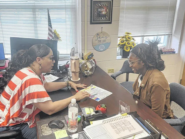 Butler Avenue Elementary principal Dr. Angela Harding-Newkirk introduces Woodlyn Pierre to some upcoming events that are taking place at the school.