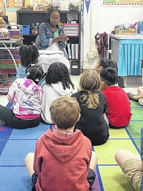 Clinton alumna Woodlyn Pierre giving instruction to her class during her internship at Butler Avenue.