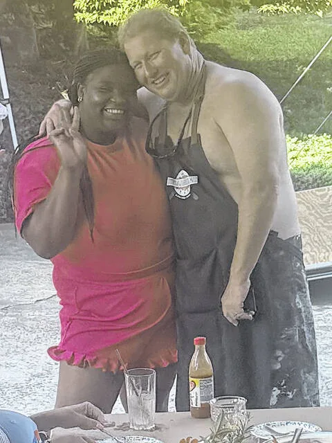 Tyler Wise and Tim Walters share a hug during a tasting two weeks ago where each chef whos working on the Low Country Boil prepared a sample of their own dish and brought a preview. The event will be held along Vance Street beside the Sampson County Courthouse on Sept. 20, starting at 2:30 p.m.
                                 Courtesy photo | Debbie Roberts