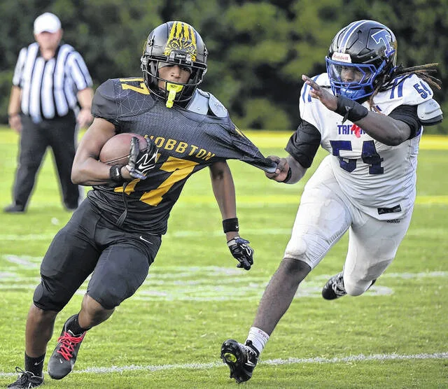 Wildcat freshman Jeremiah Lyon gets his shirt pulled away. Lyon scored two touchdowns later in the game for Hobbton.
                                 David Johnson | For the Sampson Independent