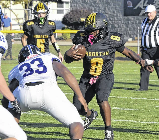 Hobbtons Isaiah Collins looks for room around the Hawks Jermaine Prince.
                                 David Johnson | For the Sampson Independent