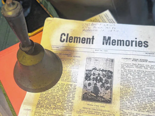 Weldon Faircloth presented two historical items from the beginning of Clement Elementary Schools history during an interview last Thursday: an original hand bell that belonged to the first principals at Clement Elementary and a copy of the first issue of Clement Memories  a school newsletter  published on May 20, 1929, which describes the school when it was founded. According to the newsletter, during the the first year, Clement had no lights, science equipment, auditorium chairs, maps, no library. There was, however, a piano that sounded more like a tin pan.
                                 Dylan Atwood | Sampson Independent