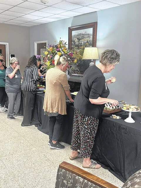 Staff of Sampson Regional take time to enjoy refreshments after comments and the sealing of the time capsule.