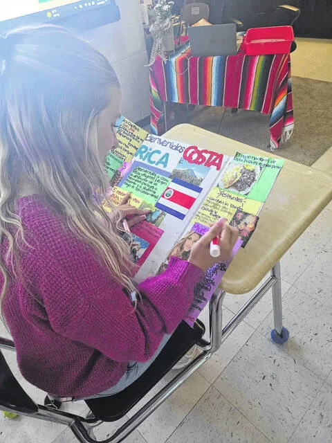 Twelfth-grader Calli Beatty creates a colorful display using the tri-fold board and markers Mrs. Hawkes class got from her grant on donors choose which was fulfilled by the NC nonprofit Exponential Scholars founded by Holly May.
                                 Courtesy Photos by LHS Teacher Yadiraliz Hawkes