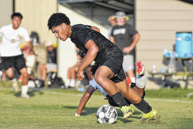 Dark Horse Marlon Munigua forces a James Kenan turnover deep in the Tigers end of the field late in the first half of Tuesdays match.
                                 Mike Carter | For the Sampson Independent