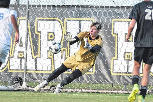 Dark Horses goalkeeper Dustin Pike zeros in on the ball as he prepares to convert on a first-half save in Clintons 5-1 win over CB Aycock Thursday afternoon.
                                 Mike Carter | For the Sampson Independent