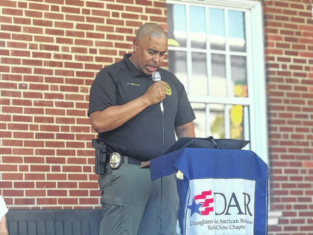 Clinton Chief of Police Adrian Matthews presents a proclamation from Mayor Lew Starling outside the Sampson County Courthouse on Thursday afternoon during the National Ringing of the Bell ceremony, declaring that the week of Sept. 17-23 will be known as Constitution Week for Clinton.
                                 Dylan Atwood | Sampson Independent