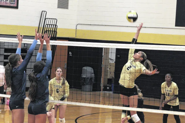 Clintons Brittany Britt extends her body on her kill against two East Duplin defenders during their conference battle on Thursday evening. The Lady Dark Horses swept their opponents 3-0 in the win.
Trevon McGlone | Sampson Independent