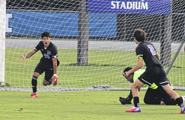 Midways Juan Melchor is pumped after he scores the opening goal in the Raiders battle with James Kenan Monday evening. Melchor converted his shot after his teammate, Carson Cain, had his shot bounce off Tigers goalkeeper. James Kenan outscored Midway 3-1 to win.
                                 Trevon McGlone | Sampson Independent