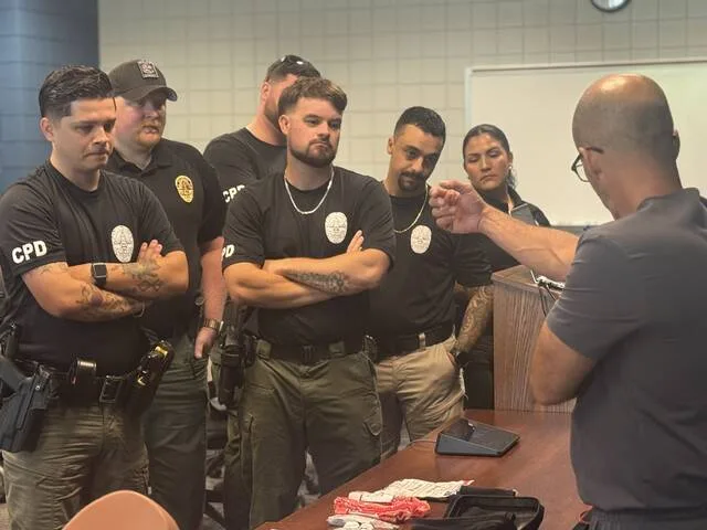 Cpl. Ricardo Rico, Lt. James Jones, Sgt. Mark Horne, Officer Alexander Chaney, Cpl. Avigail Cruz, behind Horne stands Sgt. Stephen Cannady, as they observe Dr. Andres Fleury, M.D., a surgeon at Sampson Regional Medical Center, demonstrate how to self-apply a tourniquet at Sampson Community College last Tuesday during Tactical Emergency Casualty Care training for the Clinton Police Dept.
Dylan Atwood | Sampson Independent