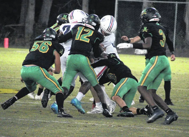 Multiple Crusaders pitch in on the group tackle to stop the Covenant Day rusher in the backfield.
Trevon McGlone | Sampson Independent