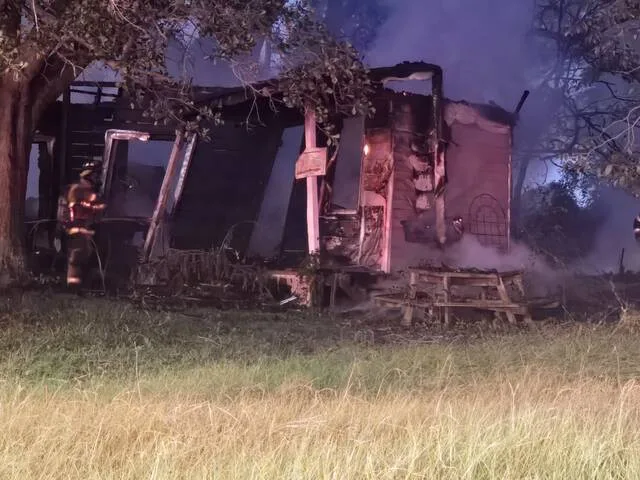 Smoke billows from the Big John Road structure destroyed Sunday night by fire.