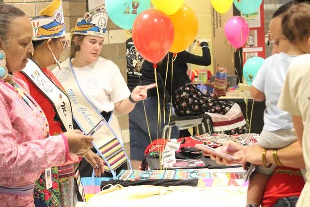 Members of the Coharie Tribe share some of their crafts and culture with visitors to their station.