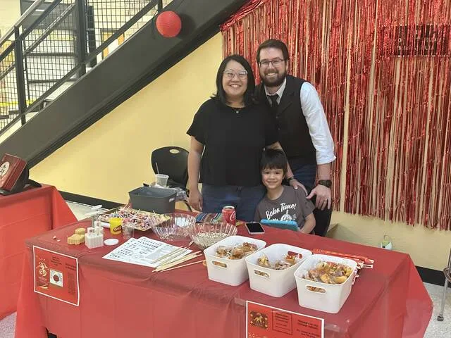English teacher Matthew West, along with his wife Ga Ming and son Jameson, host the China table during the multicultural event Friday.