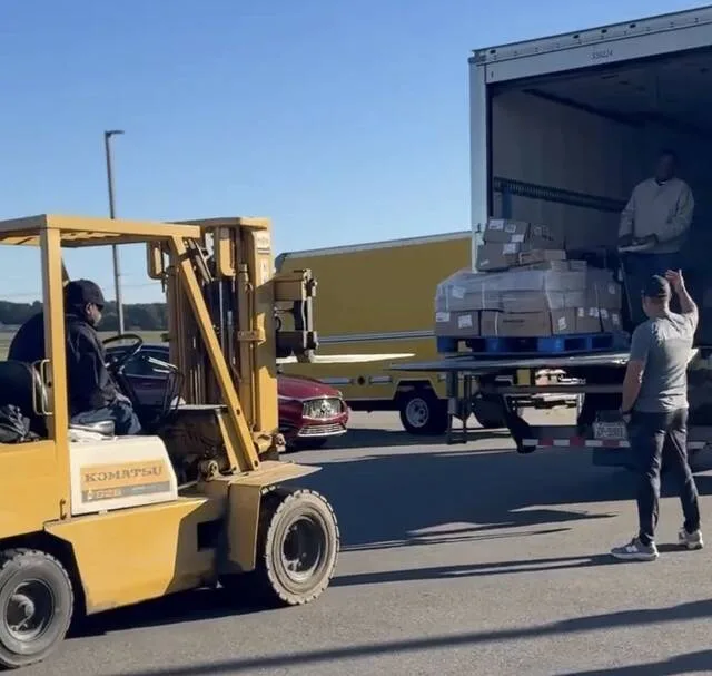City schools maintenance and child nutrition assistant Larry Deaver begins to unload crates of food boxes from the Second Harvest truck with the forklift. Dr. Linda Brunson states, He is always willing to assist in any way we need him.