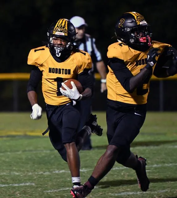 Wildcat running back Isaiah Williams follows a block from his teammate, Amir Tate, during a rush play in their game against East Bladen Friday night. Hobbton was defeated by the Eagles 46-40 in a game where both teams combined for over 86 points.
                                 David Johnson | For the Sampson Independent