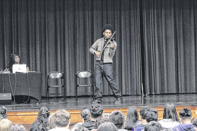 Students at Union Middle School were captivated by the wide genre of songs Tyler Butler-Figourea played in his seven-song set Friday.